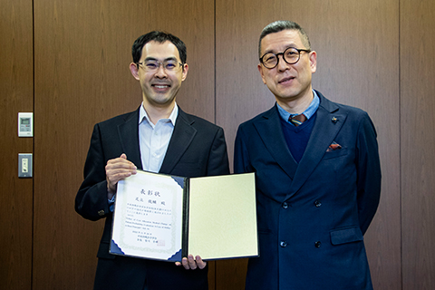 한총장(오른쪽)에게 웃는 얼굴로 수상 보고하는 아다치 선생님(왼쪽)